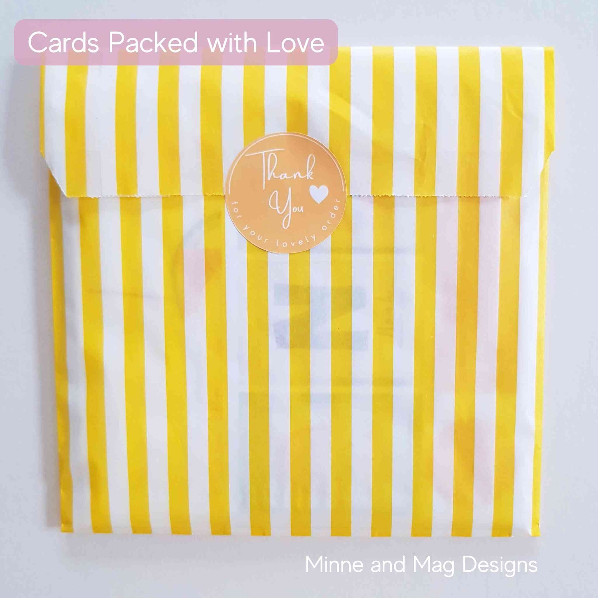 Greeting card wrapped in yellow and white striped back with Thank You sticker.