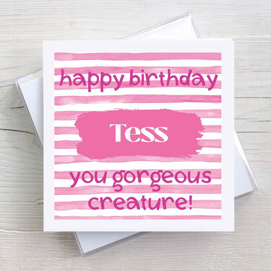 Personalised Happy Birthday card with name and message "you gorgeous creature". Pink and white striped design.