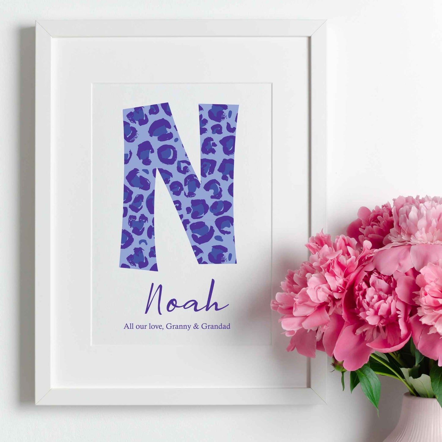 Framed Large Blue Leopard Print Initial letter, Child's Name underneath, with short positive phrase to complete. White Wooden Frame.
