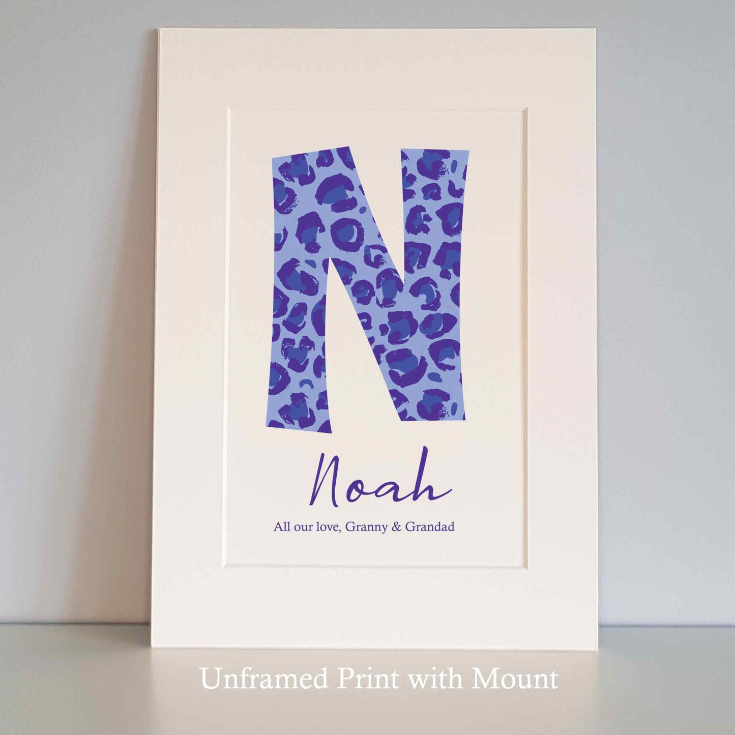 Personalised Unframed Print with large initial in Blue Leopard Print, child’s name and short quote. White mount surround.
